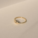 Close up of puffy signet face on solid gold initial ring by Vivi Ami